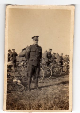 Photograph of bicycle troops with tents in the background