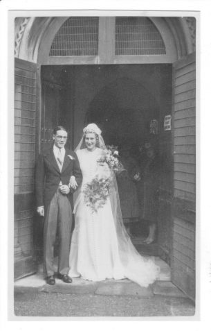 Photograph of Francis and Cynthia Price (nee Chase) as newly weds at the door of the Old Church [St Andrew's], Hove