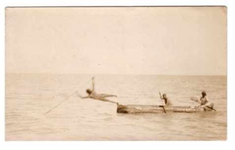 Photograph, taken by Emile Clement, of Australian Aborigine spearing a dugong or turtle