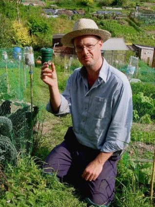 Andrew catching snails in his cabbage patch | Photo by Simon Tobitt