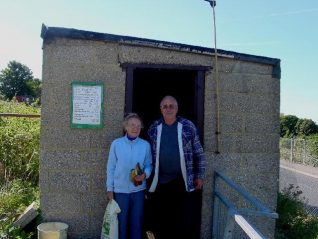 Pam Bean with Bill Burton (both site reps) outside the Tenantry Down shop | Photo by Simon Tobitt