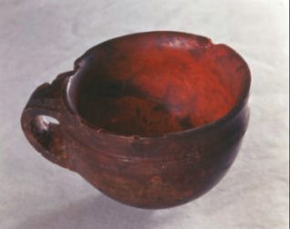 The Hove Amber Cup is considered to be one of Britain's most important Bronze Age finds. It was discovered in 1856 when a burial mound was excavated to make way for the building of Palmeira Avenue. Inside the mound was an oak coffin carved from a single tree trunk. The coffin contained bone fragments, a dagger, a whetstone and an axe head as well as the precious Amber Cup. The grave goods are over 3,500 years old. | Royal Pavilion and Museums Image Store