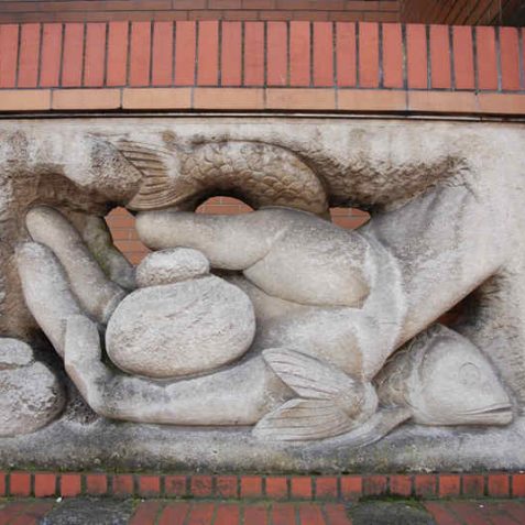 On the North Road facade of the Brighthelm Centre is a sculpture by John Skelton of the biblical loaves and fishes story | Photo by Tony Mould