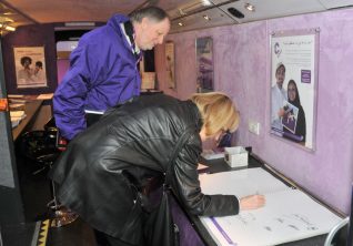 Jennifer signs the visitors book | Photo by Tony Mould