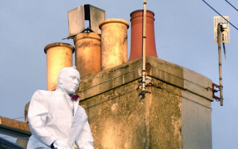 Man in a white tuxedo on the roof