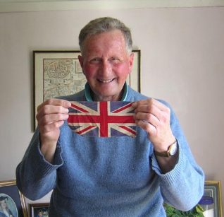 Tony Simmonds holding the flage he flew on his bike on VE Day | Photograph taken by Zoe Woods