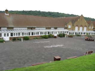 Rear view of the Junior School as seen from the grass banking covering two wartime bunkers. | Photo by Ron Spicer