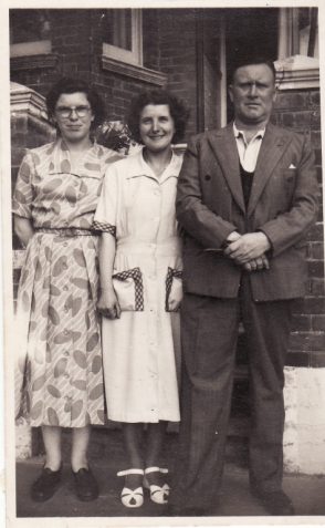 Photo of Margaret Rich aged 15 with Win and Ted in front of house in Balfour Road, Brighton, 1948