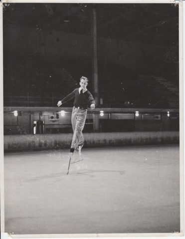 Photograph of Reg Moores on ice skate 'stilts'