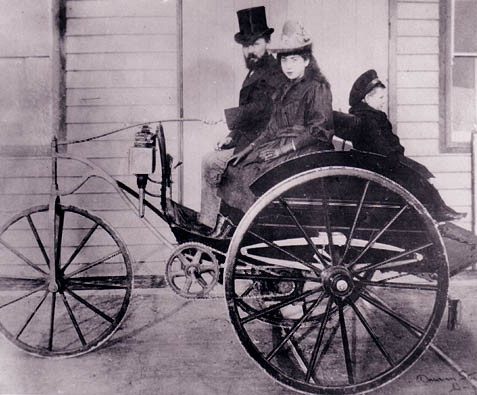 Magnus Volk (1851-1937) in his electric dog cart outside Volk's electric rail office in Madeira Drive c 1897, with sister-in-law Deborah and his son Bert. | Image reproduced with permission from Brighton History Centre