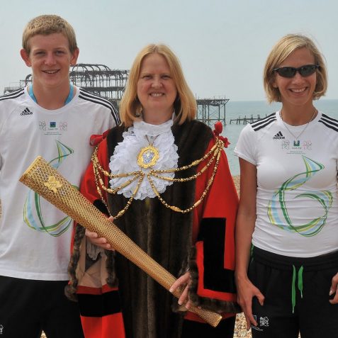 The Mayor, holding the torch, with local athletes Alex Fraser and Sophia Warner | Photo by Tony Mould