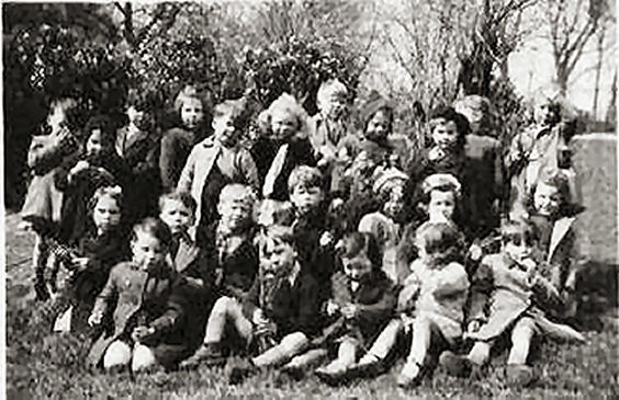 I am on the second row from the front, first on the left, kneeling and holding a skipping rope | From the private collection of Maralyn Eden