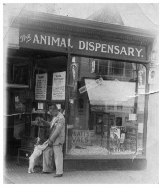 Dad and canine friend outside the shop. Click on the image to open a large version in a new window. Click on image again to enlarge | From the private collection of Tony Hill