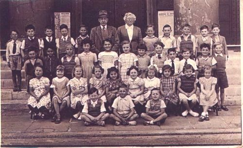 Class Photo taken outside St Margarets Chuch 1950, with Mr Mason the Headmaster and Mrs Standing, Class teacher | From the private collection of John Wignall