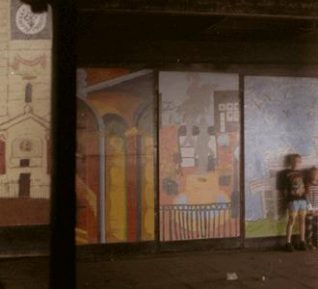 Schools' pictures of Brighton on display in the murk below the West Pier, 1992. On the left is part of a picture of the clock tower in Queen's Park. | Photo by David Fisher