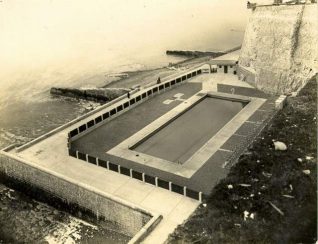 Rottingdean Swimming Pool, c. 1935: Aerial view of Rottingdean Swimming Pool. This opened on 29 July 1935 to replace bathing facilities lost when the sea wall and Under cliff walk were built. It was a seawater pool and measured 100 feet by 35 feet. It was filled in with concrete in 1994. | Image reproduced with kind permission from Brighton and Hove in Pictures by Brighton and Hove City Council