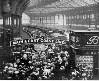 Passengers at Brighton Station, c. 1905. A crowd of passengers on Platform 3 at Brighton Station. A sign hanging from the overhead platform sign advertises times of return trains to different parts of London. It is likely that these passengers are making their return journey home after a bank holiday excursion to Brighton. | Image reproduced with kind permission from Brighton and Hove in Pictures by Brighton and Hove City Council