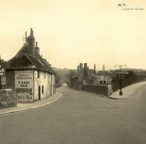 London Road, c. 1930s: London Road, Patcham at the junction with Old London Road. The Patcham Bypass, as this stretch of London Road is known, opened in 1926. Posters advertise the Hippodrome and George Newman and Co., who had a car showroom at 40 Old Steine | Image reproduced with kind permission from Brighton and Hove in Pictures by Brighton and Hove City Council
