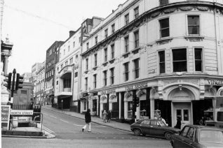 North Street and Queen's Road, 28 January 1974: This photograph shows an early Virgin Records shop at the western end of North Street. Nearby the Regent Cinema is closed awaiting demolition. Both of these buildings were demolished in 1974 and the site is now occupied by Boots the Chemists. A blue police box can be seen above the now filled-in public toilets under the clock tower | Image reproduced with kind permission from Brighton and Hove in Pictures by Brighton and Hove City Council